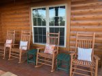 Rocking chairs and patio side tables to relax and gaze out at sunset over mountains